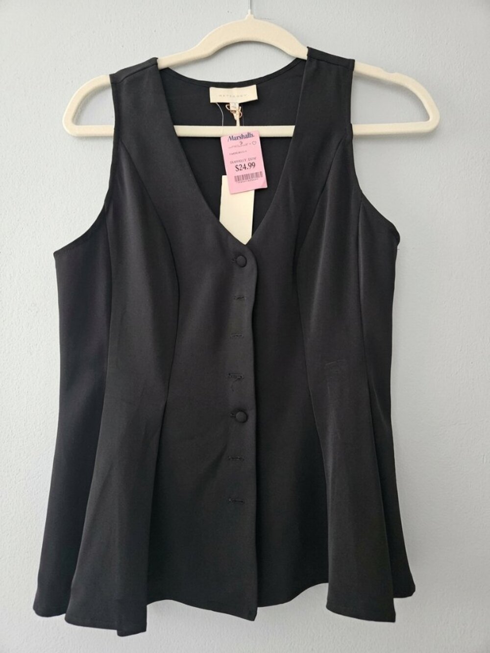Black sleeveless peplum vest